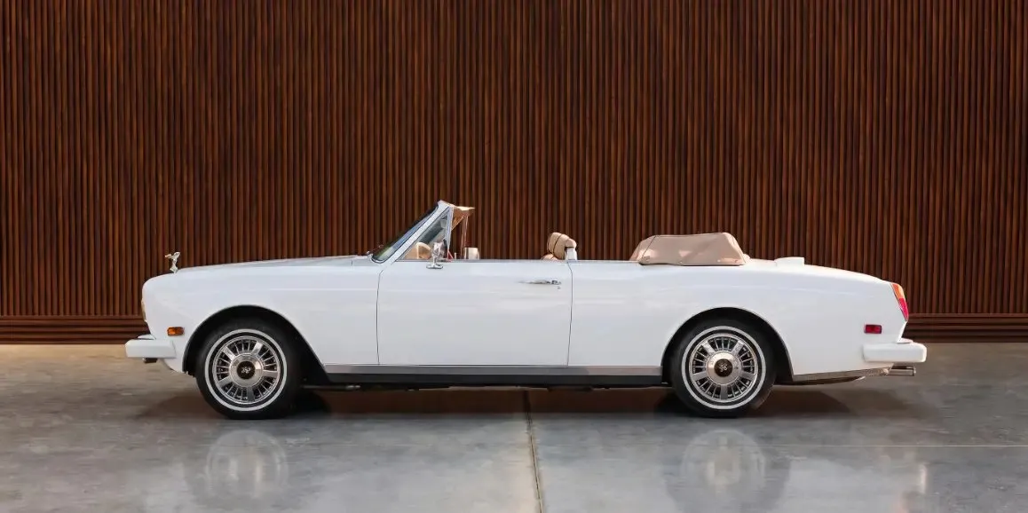 Rolls-Royce Corniche 1975 finished in white, outer view; convertible roof visible Rolls-Royce Corniche 1975 finished in white, outer view; convertible roof visible