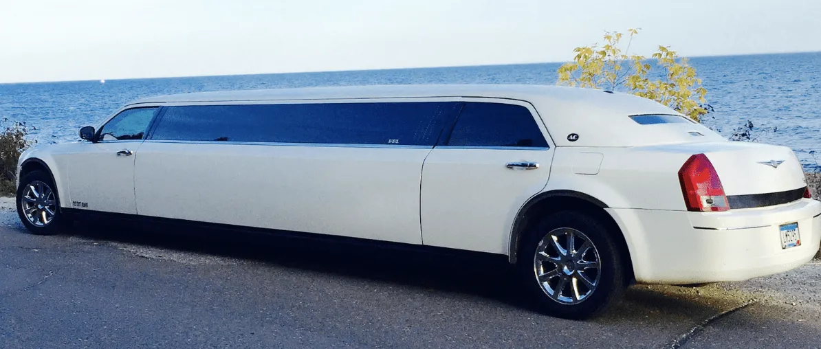 White C300 Limousine exterior with tinted windows, photo 3 for wedding car rental