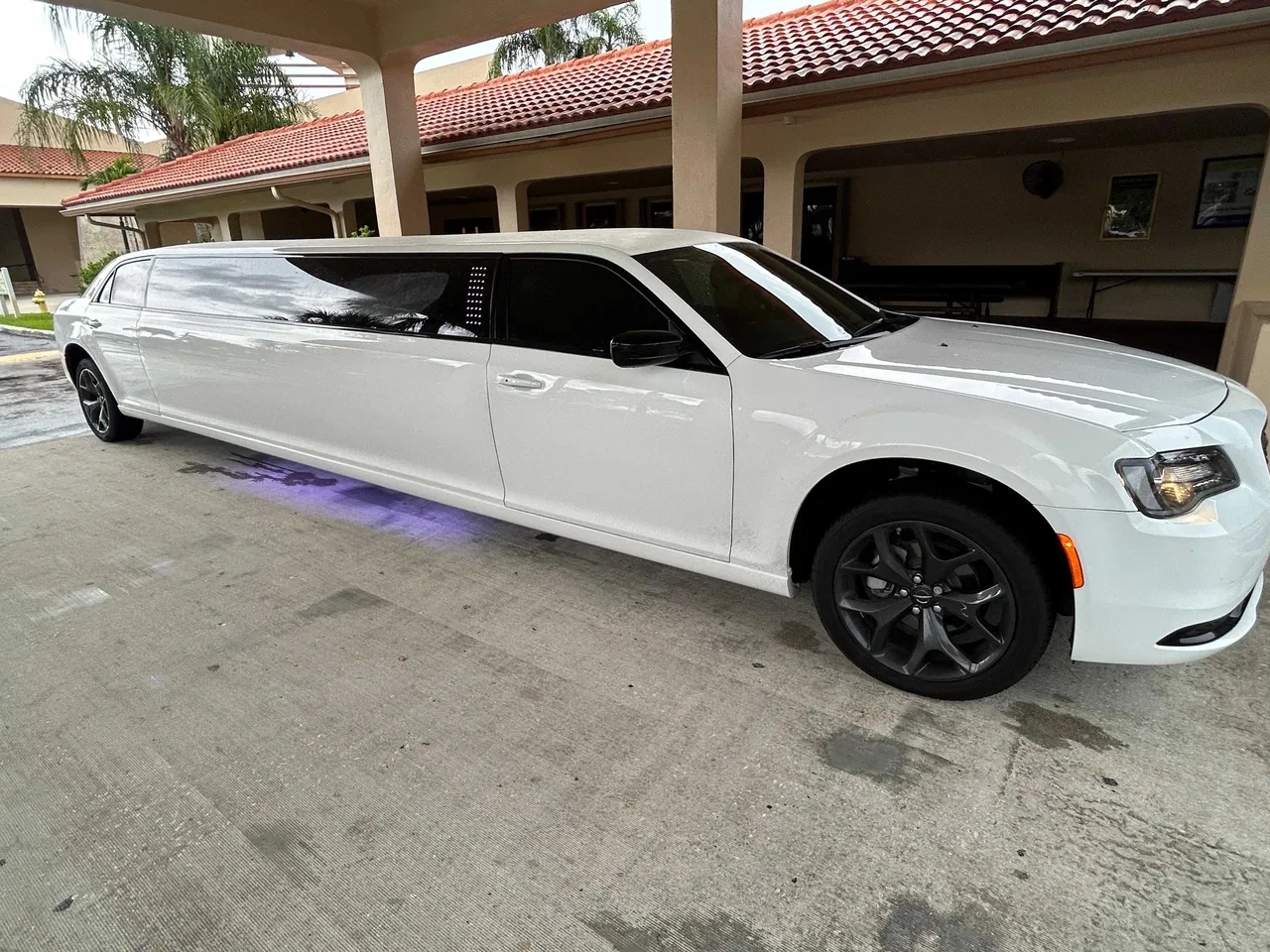 Black C300 Limousine with tinted windows for wedding car rental