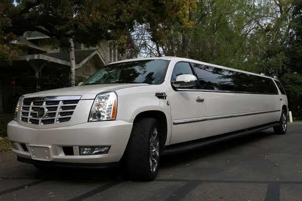 White Cadillac Escalade Limousine with tinted windows for wedding car rental