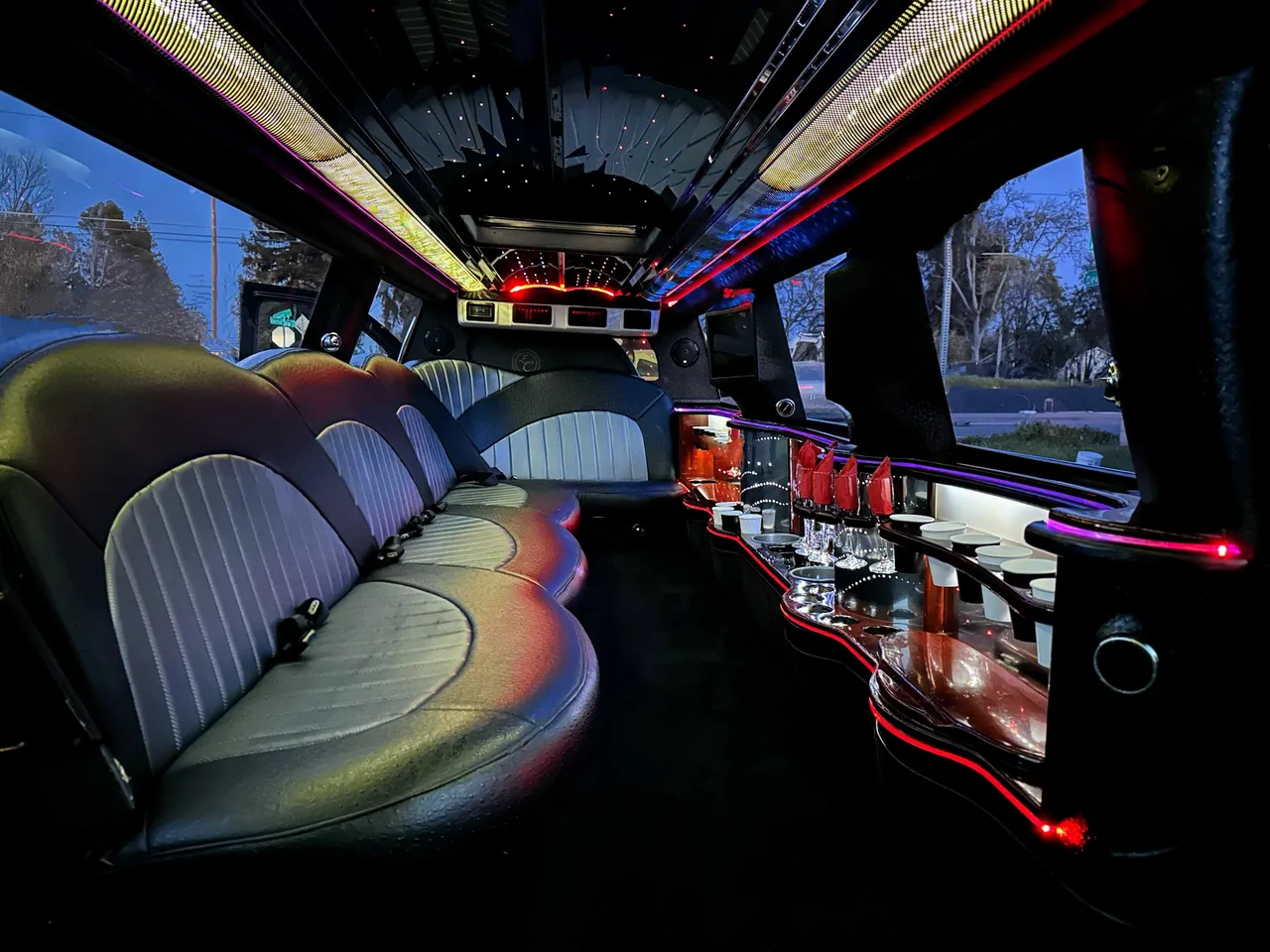 Cadillac Escalade Limousine Cadillac Escalade Limousine interior with LED accent lighting, LED ceiling lighting and bar area for wedding car rental