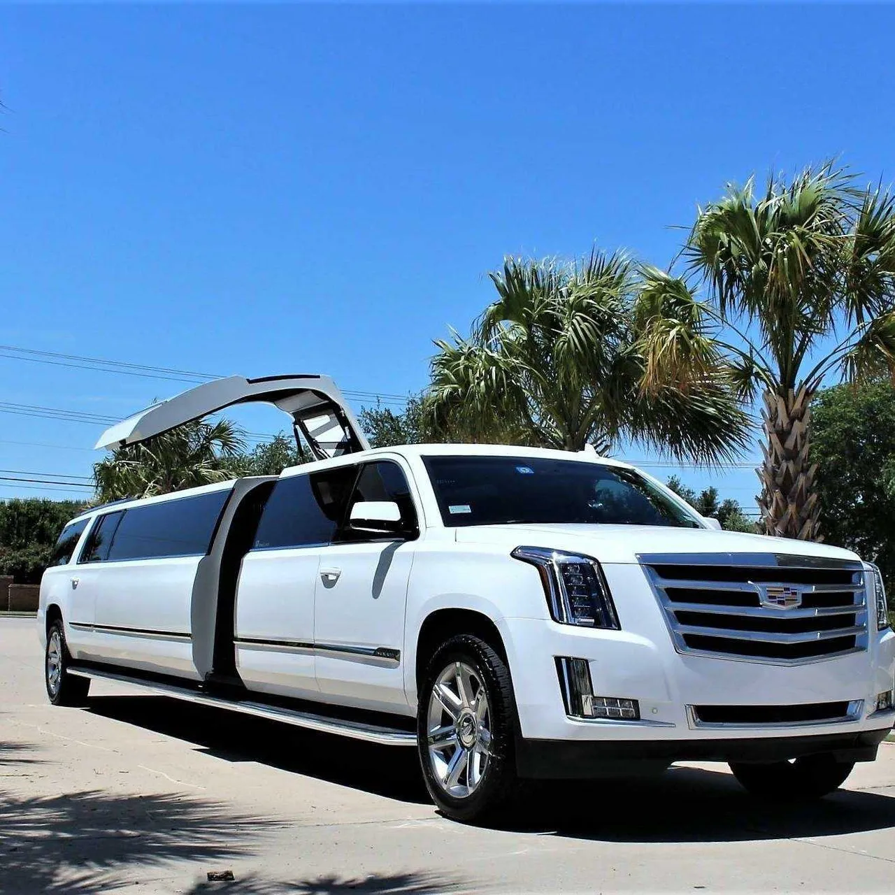 White Cadillac Escalade Limousine with tinted windows for wedding car rental