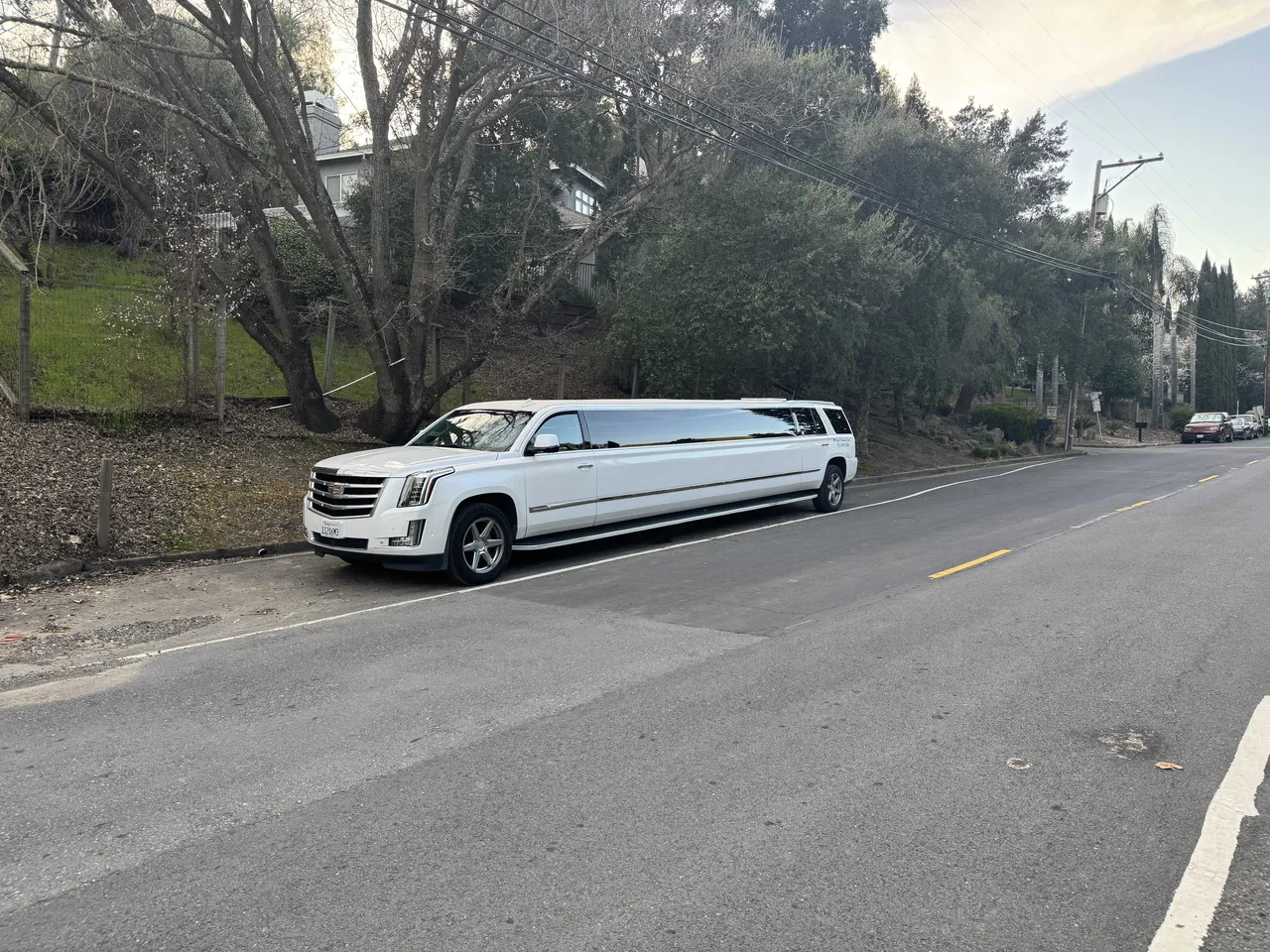 Cadillac Escalade Limousine White Cadillac Escalade Limousine with tinted windows for wedding car rental