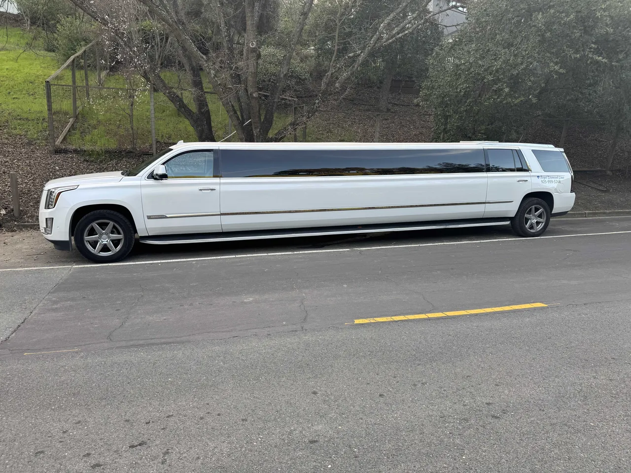 White Cadillac Escalade Limousine exterior with tinted windows for wedding car rental
