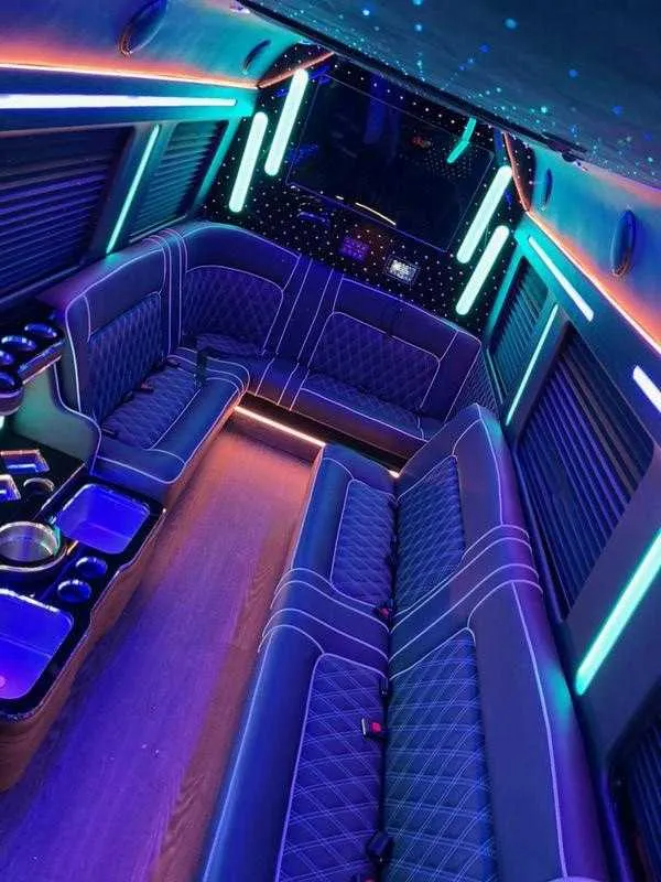 Cadillac Escalade Limousine interior with sofa-style seating, window shades and LED accent lighting for wedding car rental