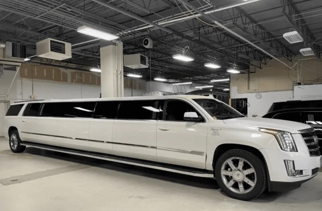 White Cadillac Escalade Limousine with tinted windows for wedding car rental