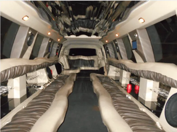 Cadillac Escalade Limousine, cabin interior; perimeter lounge seating and mirrored ceiling visible