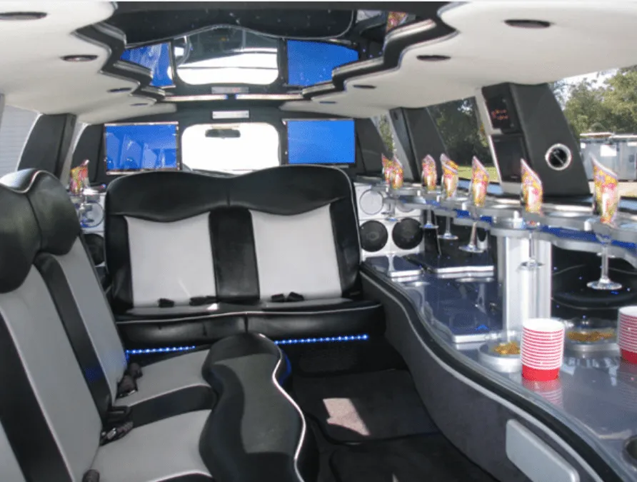 Dodge Charger interior with LED accent lighting, bar area and glassware holders for wedding car rental