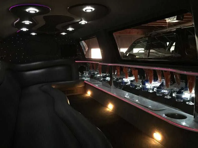 Ford Excursion Limousine interior with LED accent lighting, starlight or fiber-optic ceiling and bar area for wedding car rental