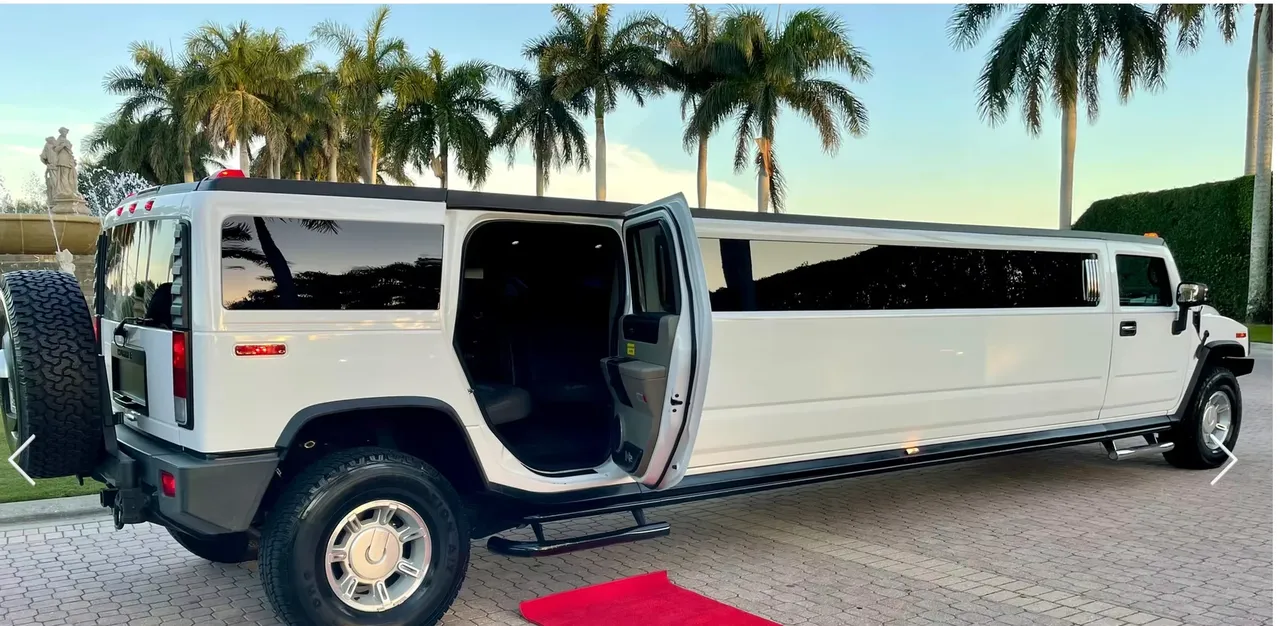White 15 Passenger Hummer H2 with tinted windows and running boards for wedding car rental
