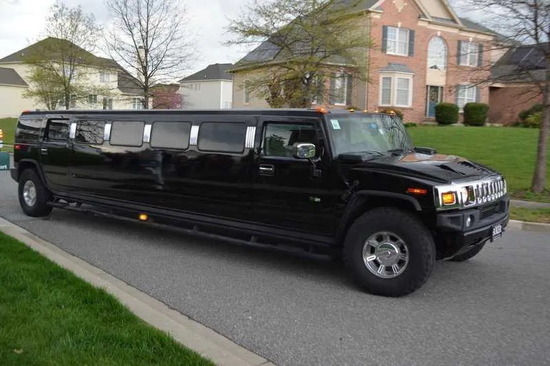 Black Hummer H2 Limousine with tinted windows for wedding car rental