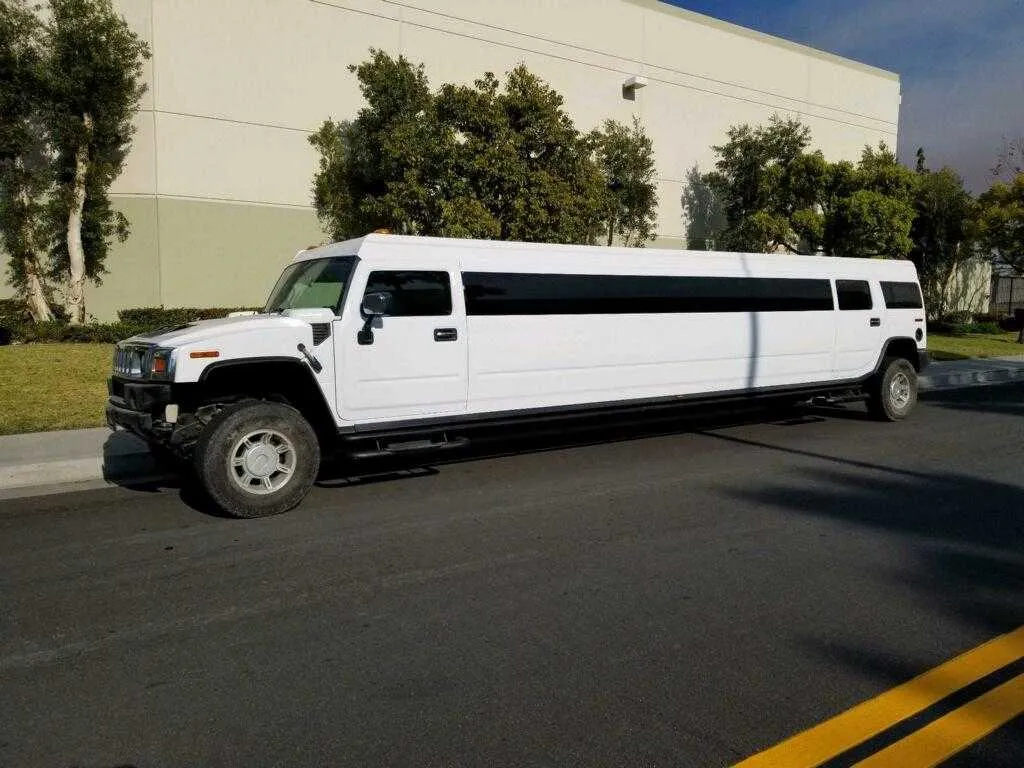 White Hummer Limousine with tinted windows for wedding car rental