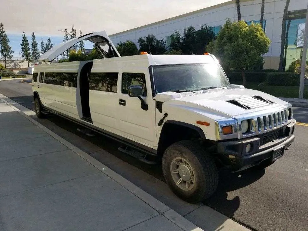 White Hummer Limousine exterior with tinted windows and bridal (jet) door for wedding car rental