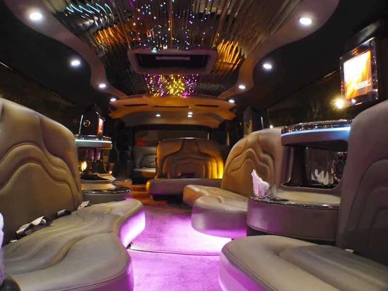 Hummer Limousine interior with LED accent lighting, starlight or fiber-optic ceiling and TV screens for wedding car rental