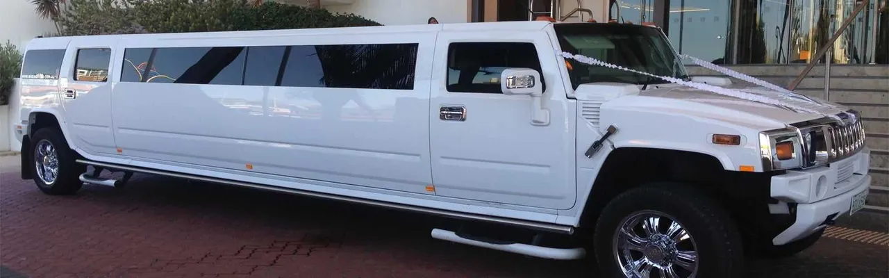 White Hummer Limousine with running boards for wedding car rental