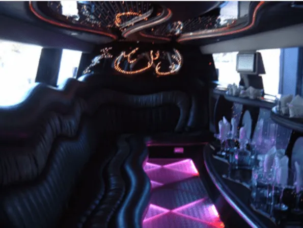 Hummer Limousine, cabin interior; lit dance floor and bar area visible, take 3