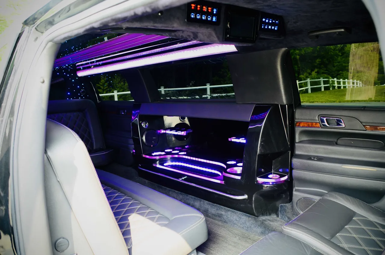 Lincoln MKT Limousine interior with LED accent lighting, LED ceiling lighting and bar area for wedding car rental