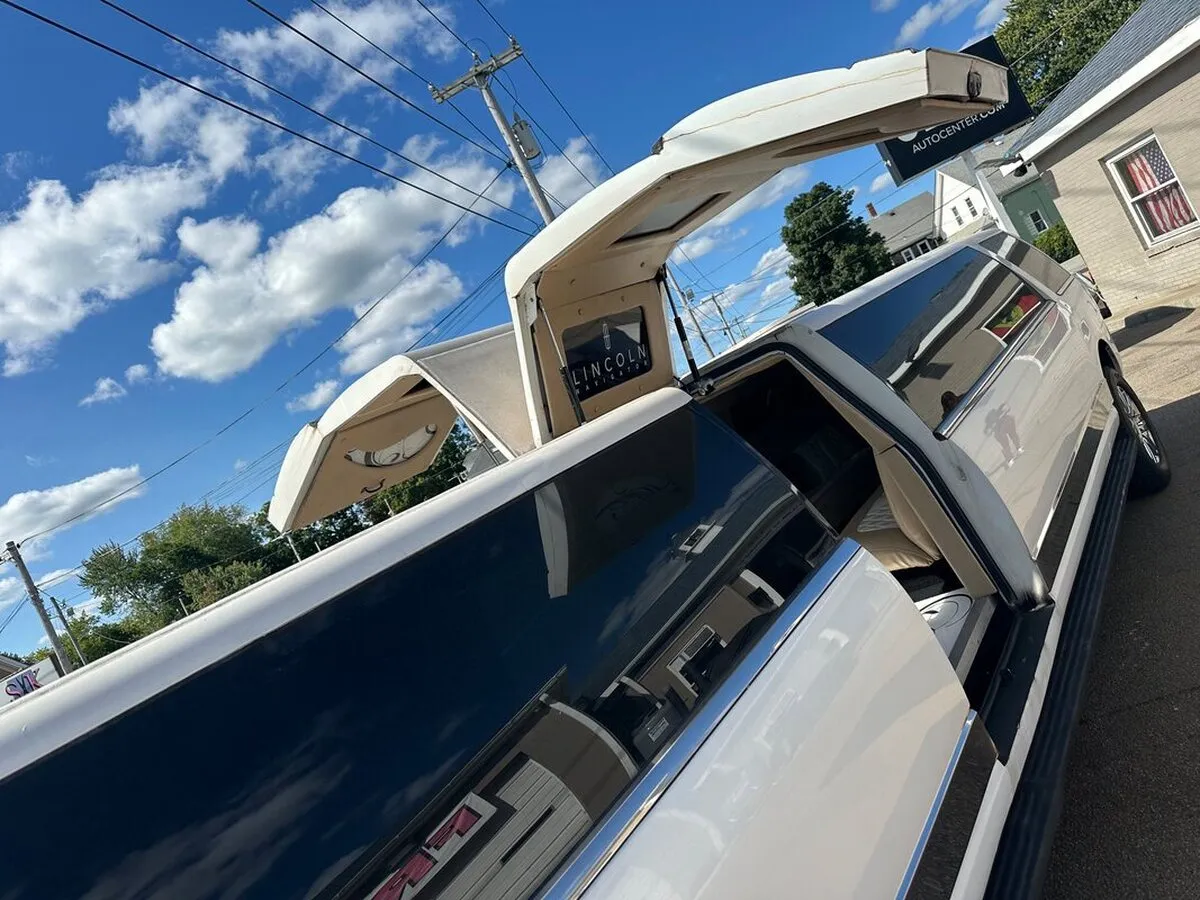 White 18 Passenger Lincoln Navigator exterior with tinted windows, photo 5 for wedding car rental