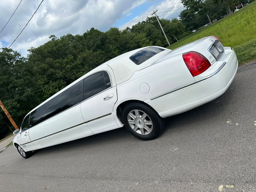 White Lincoln Town Car Limousine exterior with tinted windows, photo 5 for wedding car rental in Windsor, CT