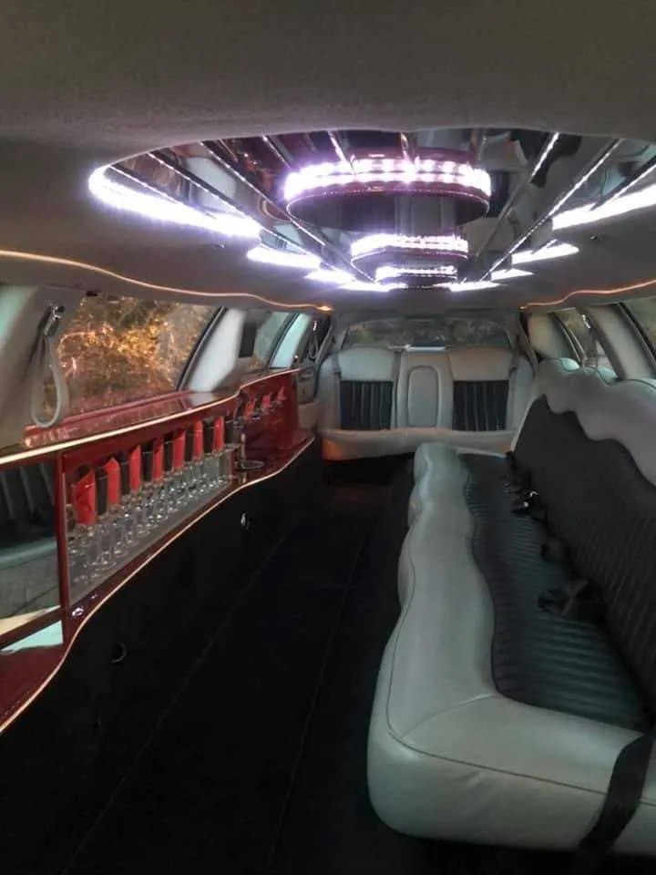 Lincoln Town Car interior with LED ceiling lighting and bar area for wedding car rental