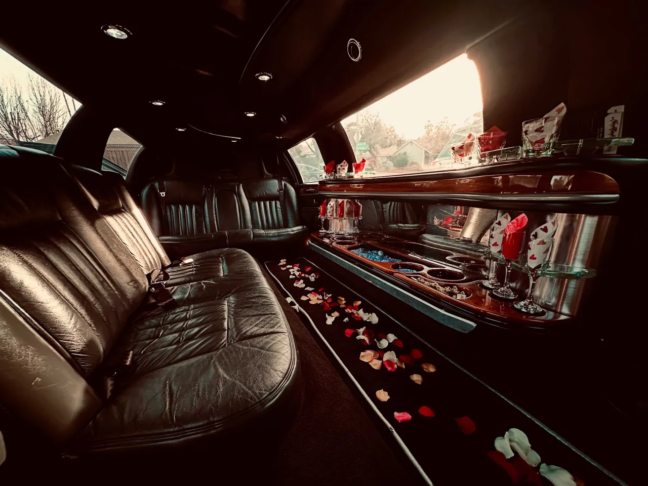 Lincoln Town Car Limousine interior with perimeter lounge seating, cup holders and bar area for wedding car rental