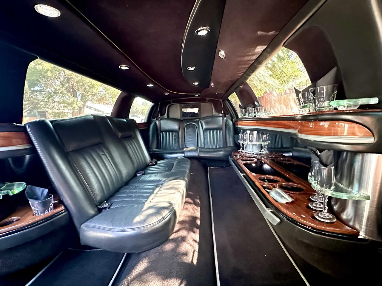 Lincoln Town Car Limousine interior with perimeter lounge seating, cup holders and bar area, photo 4 for wedding car rental