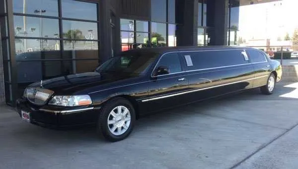Black Lincoln Town Car Limousine Lincoln Town Car Limousine finished in black; tinted windows visible