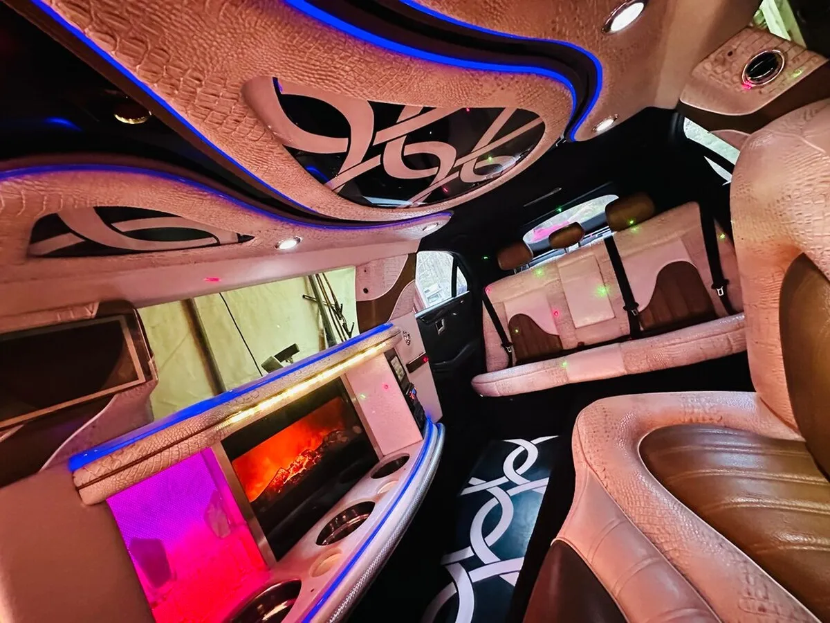 Mercedes-Benz Jet Doors Limousine interior with perimeter lounge seating and LED accent lighting for wedding car rental in Capitol Planning Region, CT
