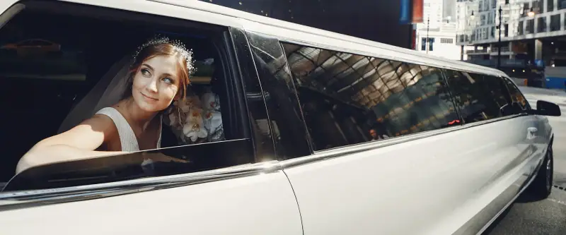 Bride looking out of her wedding limousine for wedding limo rental in Hornitos, CA
