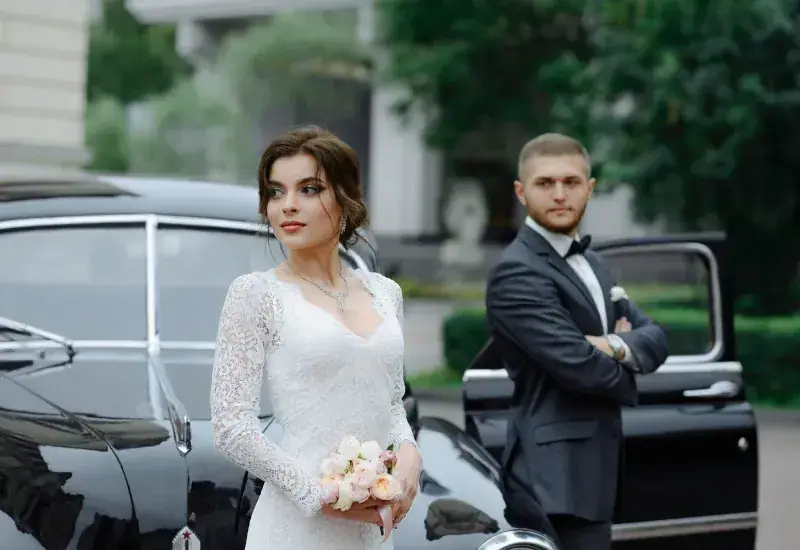 Bride and groom beside their wedding car — Grand Entrance